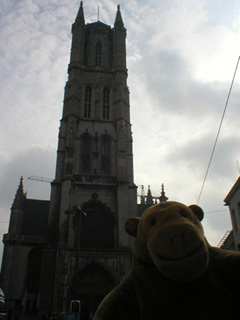 Mr Monkey looking up at the tower of St Baafs