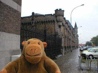 Mr Monkey walking past a trawler in a dry dock