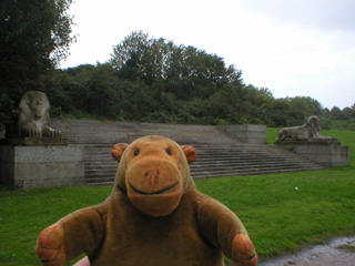 Mr Monkey looking at some steps flanked by sphinxes