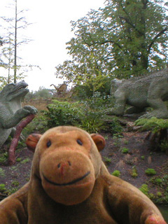 Mr Monkey looking at an Iguanadon, a Pteradactylus, and a Hylaeosaurus