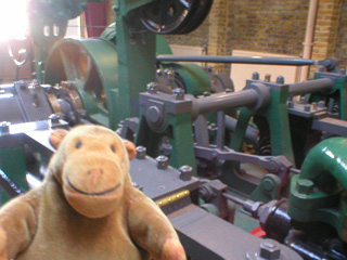 Mr Monkey looking at an old driving engine