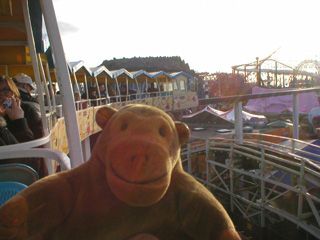 Mr Monkey leaning out to see the front of the monorail train