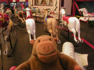 Mr Monkey riding on the Derby Racer