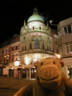 Mr Monkey looking at the Grand Theatre after dark