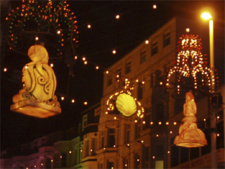 An illuminated octopus and mermaid fixed to a lamppost