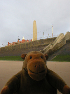 Mr Monkey looking at Blackpool's War Memorial from under the North Pier