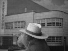 Monkey approaching old Greyhound bus station (black & white)